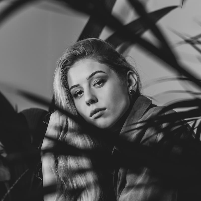 Woman seated at home during an online breakup therapy session.